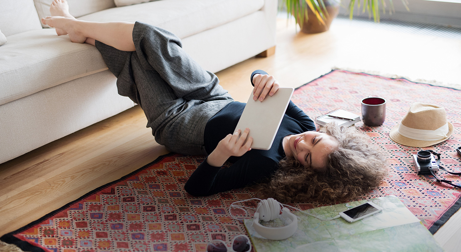 woman laying on floor with tablet