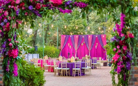 elegant outdoor reception area with pink and purple decor 