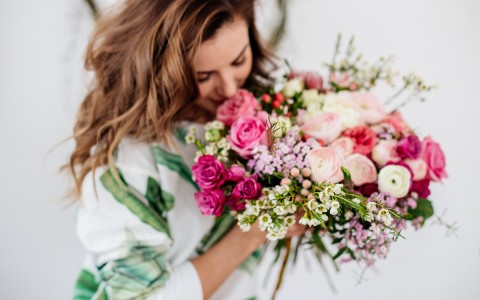 woman smelling rose bouquet 
