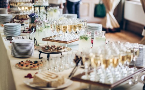 buffet area with glasses of champagne and pastries 