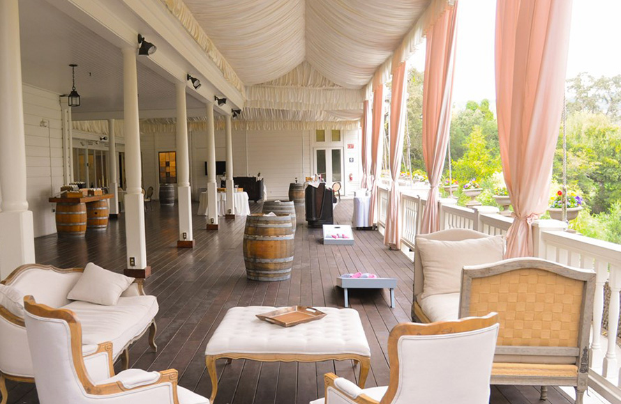 porch area with pink curtains and decorative seating