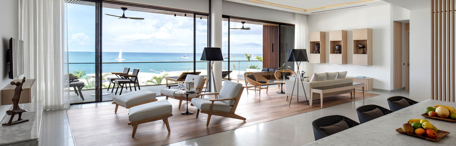 Interior of Silversands Grenada penthouse suite living and dining area looking out over ocean