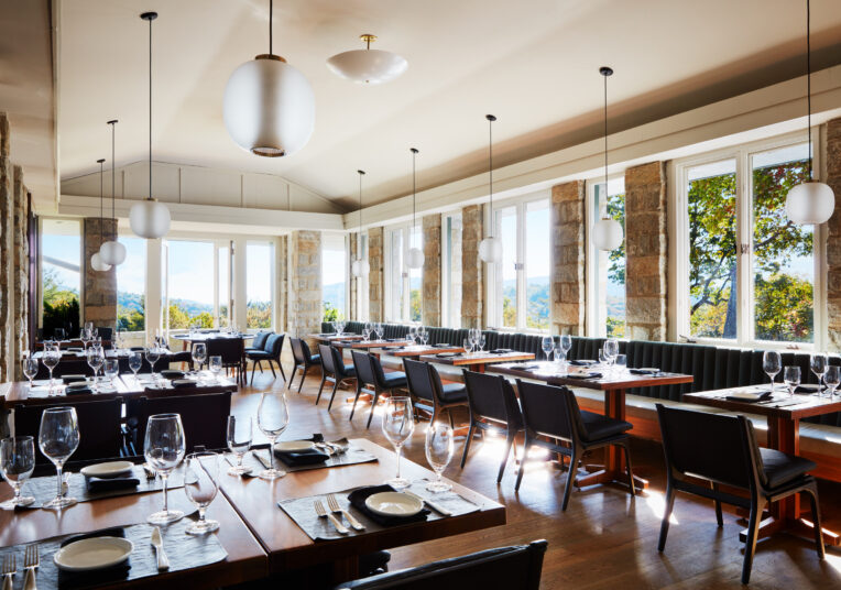 a restaurant tables set up with glasses of wine