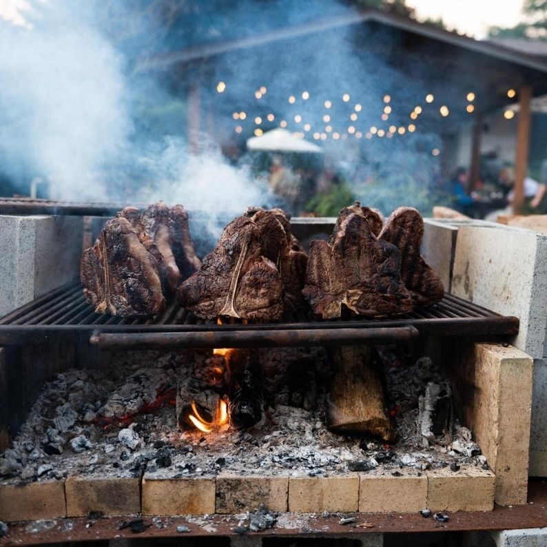 smoking steaks being cooked