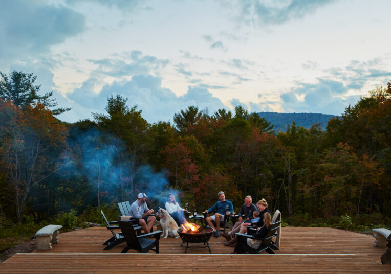 group of people gathered around the fireplace