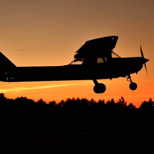 a small plane with the sunset in the background