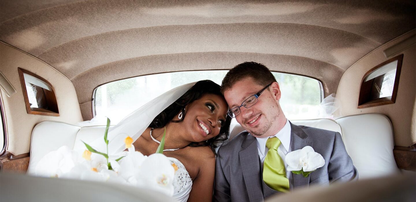an african american bride and a white man in a car