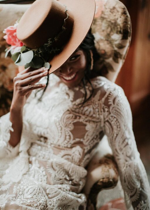 an african american bride wearing a hat