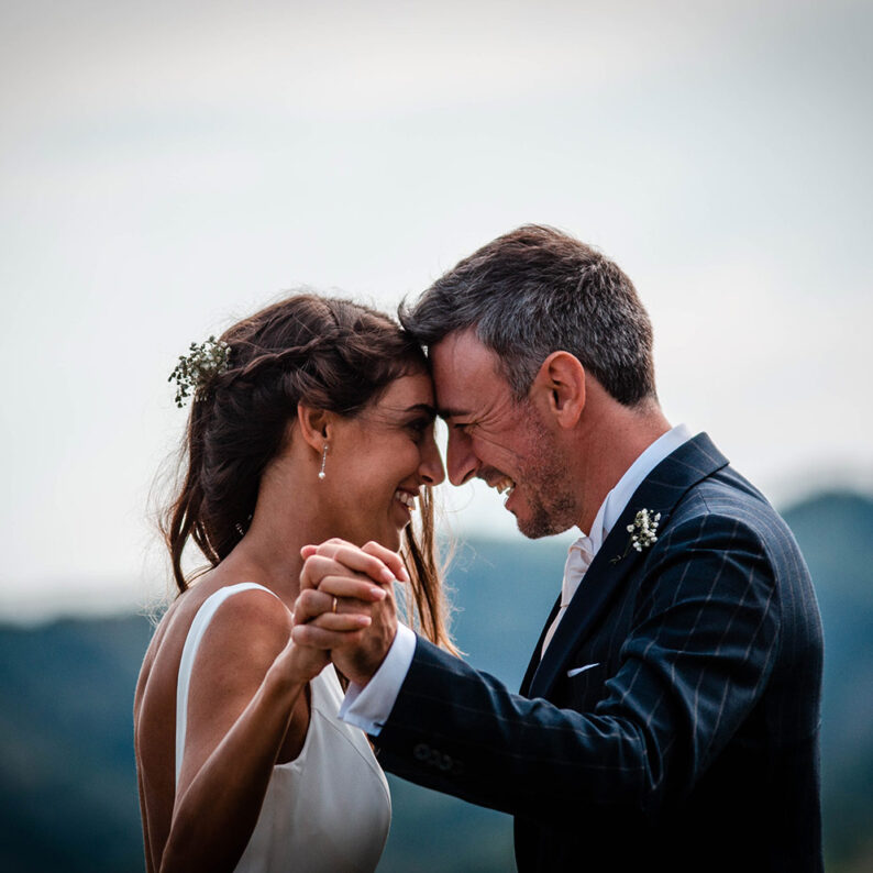 a couple standing by each other with holding their hands