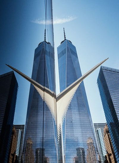 a view of the one world trade center from behind another building