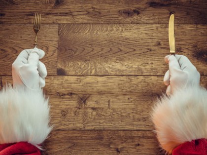 Santa Clause's hands holding a fork and knife