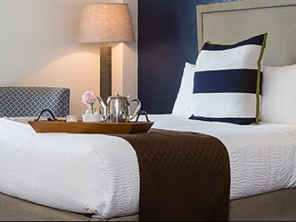 Bedroom with two beds, a desk and two chairs