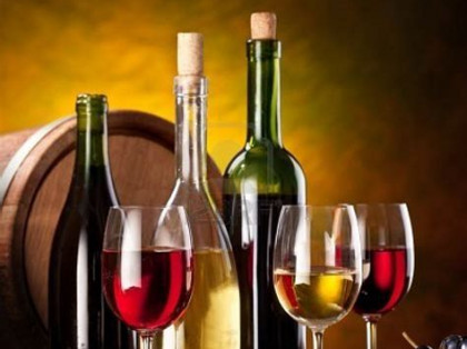 Wine Barrel with Bottles and Glasses of Red and White Wine