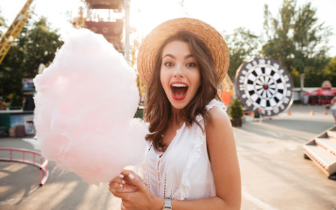 girl holding cotton candy at fair