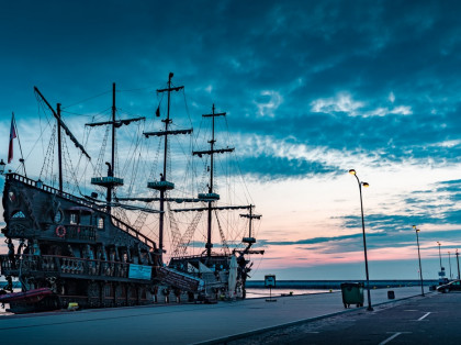 pirate ship docked at sunset 
