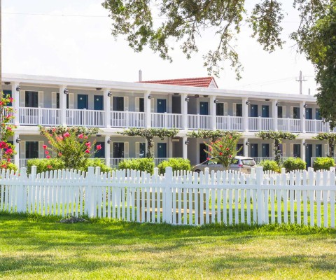 Hotel with white picket fence
