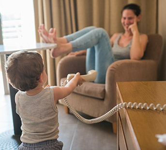 Toddler handing phone to woman