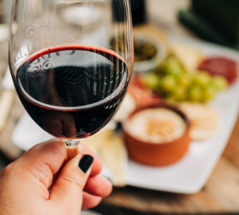 hand holding a glass of red wine