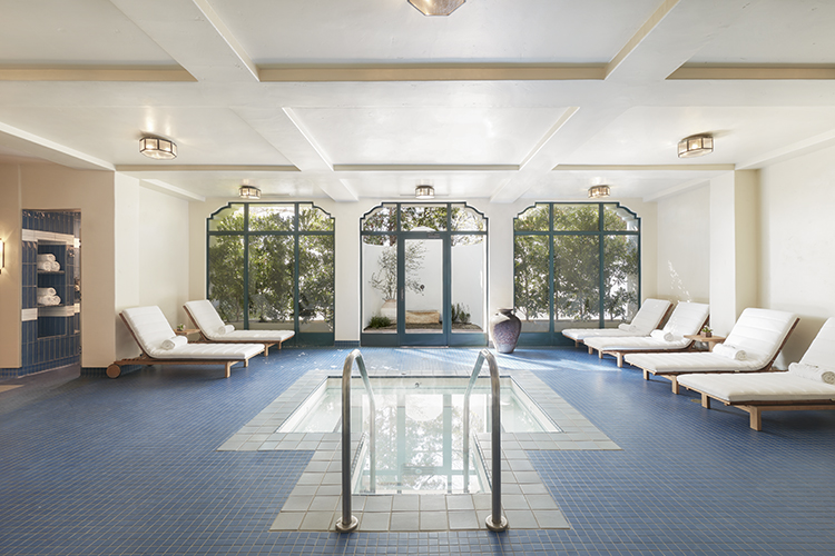 view of a jacuzzi of property and some chairs by the sides