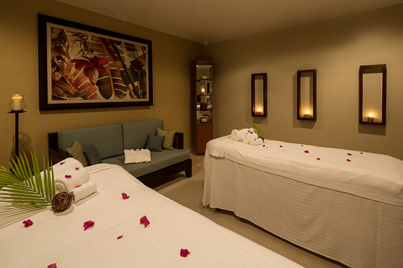 couples massage room with rose petals on the massage beds