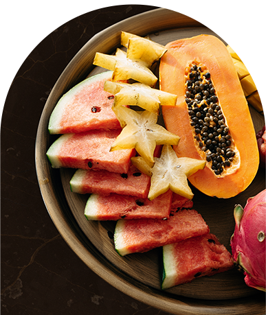 a plate full of watermelon, papaya and other tropical fruits