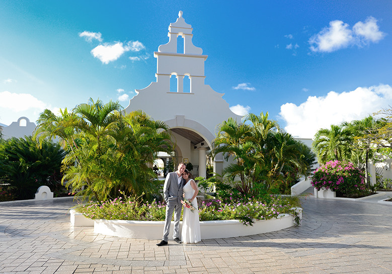 view of newlywed couple standing at hotel entrance
