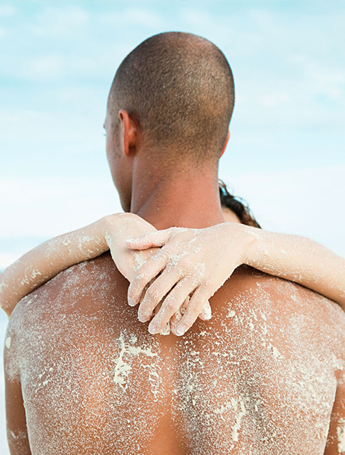 a couple embracing each other on the beach