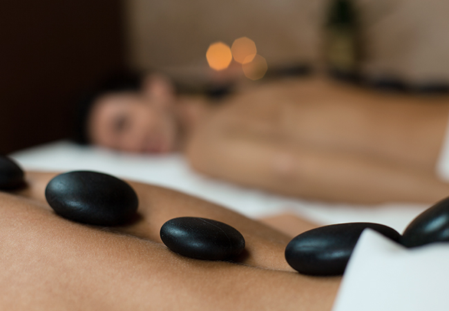 Woman relaxing at a spa with rocks on her back