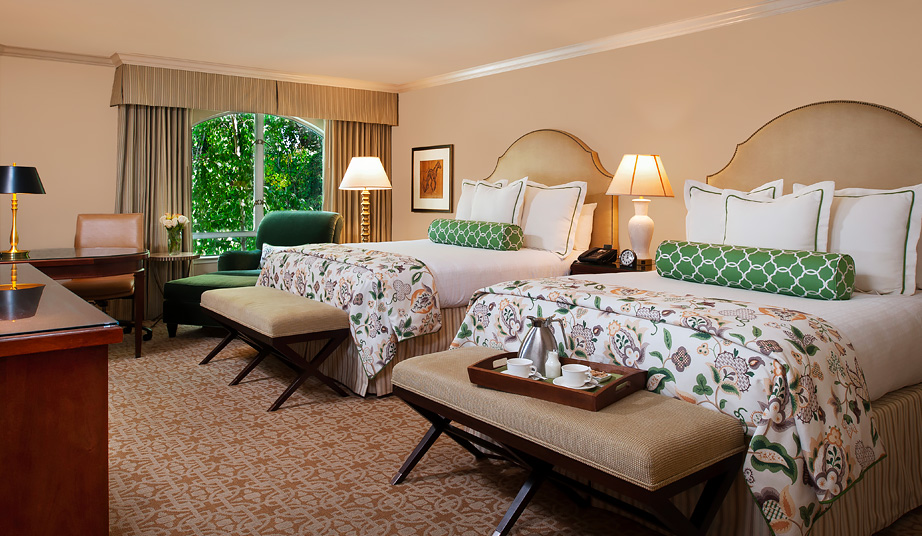 large room with 2 queen beds, beige footers, and large window large room with 2 queen beds, beige footers, and large window