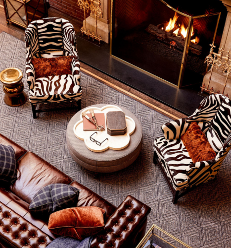 a table with a fireplace and chairs