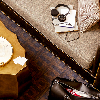 image of headphones and notebook on a couch next to a duffle bag