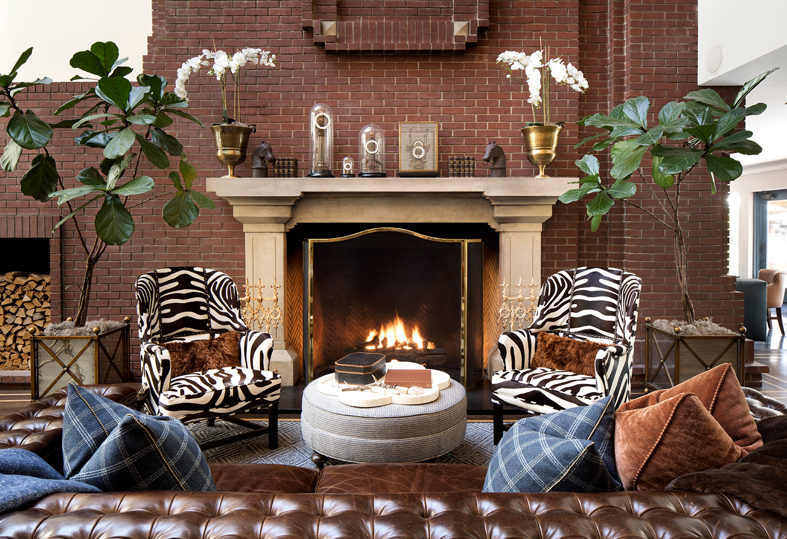 decorative seating area by a lit fireplace