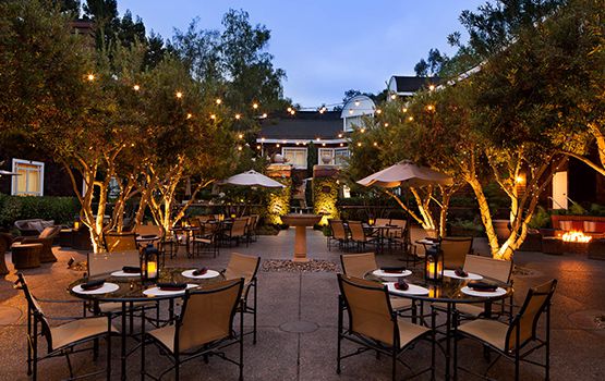 Stanford Park Hotel Weddings California Wedding Venues Courtyard Dining Tables In The Evening With Lighting On Trees