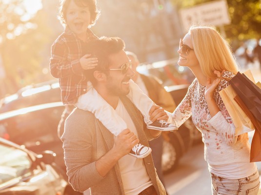 a family standing outside with their son