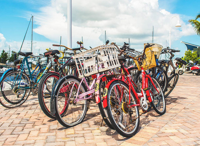 colorful bikes on a beige brick side walk