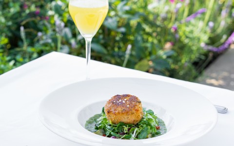 brunch crab cake on table with mimosa