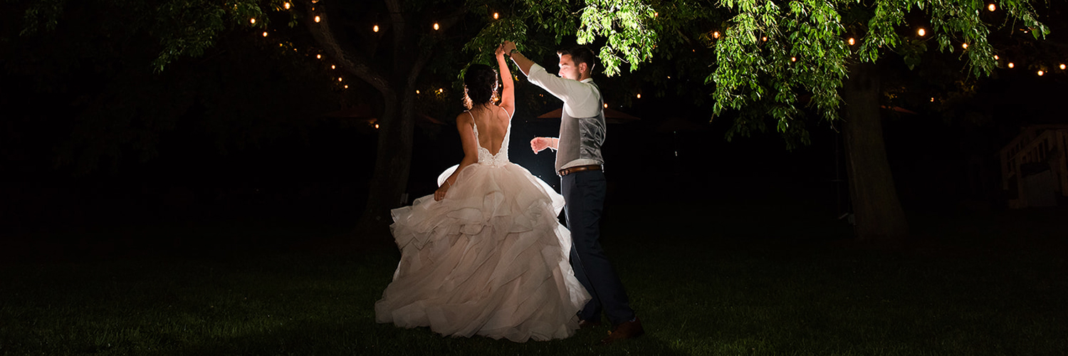 bride and groom dancing in the nature at night