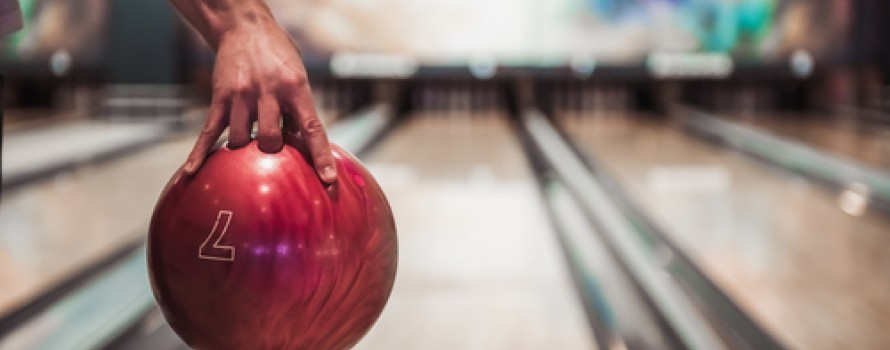 hand holding a red bowling ball