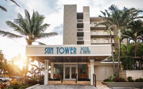 sun tower hotel entrance with palm trees all around