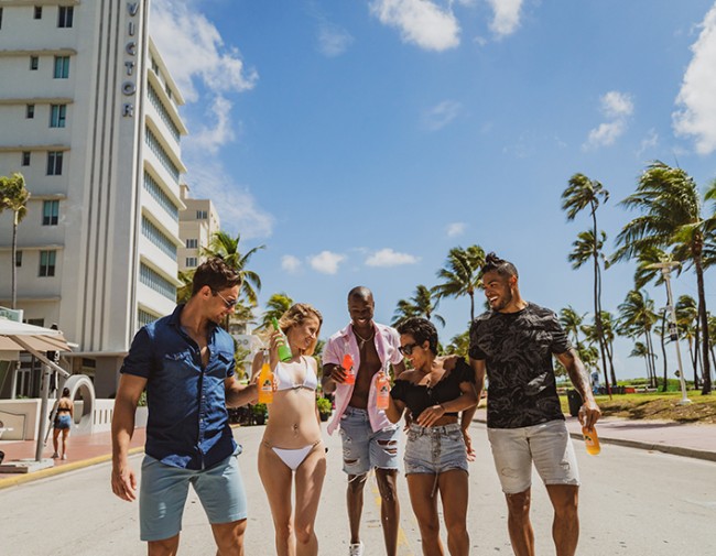 group of friends walking down the street near the beach