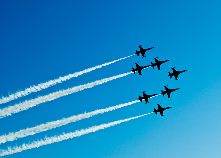 7 jets flying next to each other in the clear blue skies during the air show