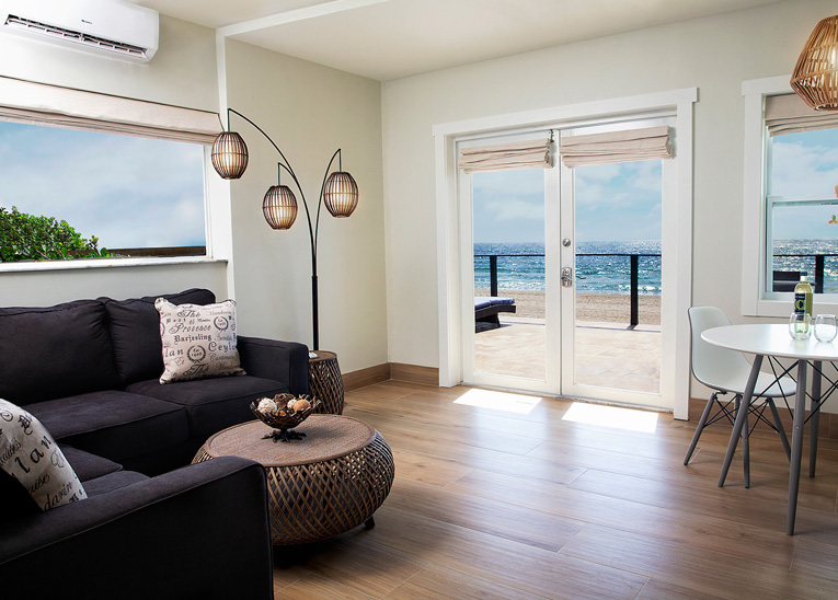 modern decor within the living room of the oceanfront deluxe suite with a patio outdoors
