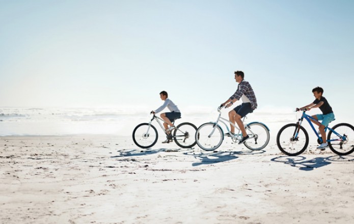 Family biking on the beach