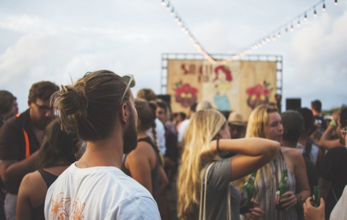 Group of music festival fans at a stage