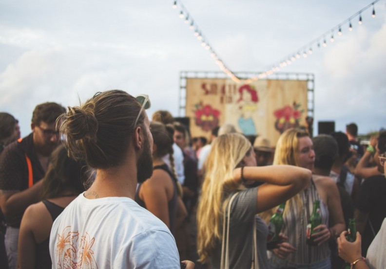 Group of music festival fans at a stage
