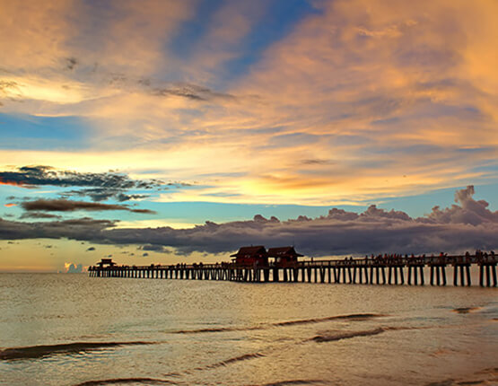 sunset sky with pier over the water