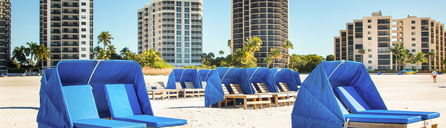 blue lounge chairs on the beach