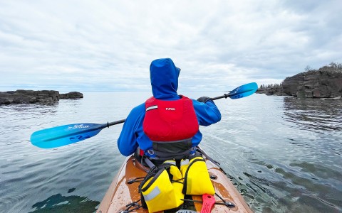man kayaking on a cloudy day
