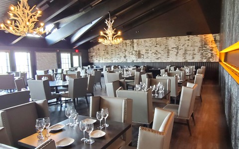 elegant dining area with cabin themed chandeliers 