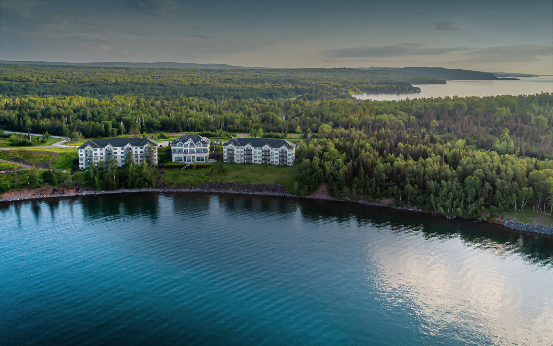 aerial view of resort surrounded by a forest